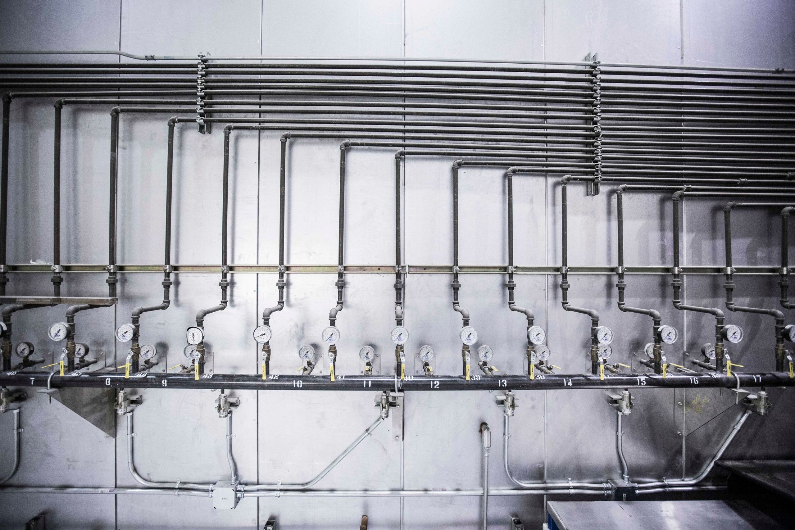 Industrial water piping system with multiple gauges and valves, illustrating water management solutions.
