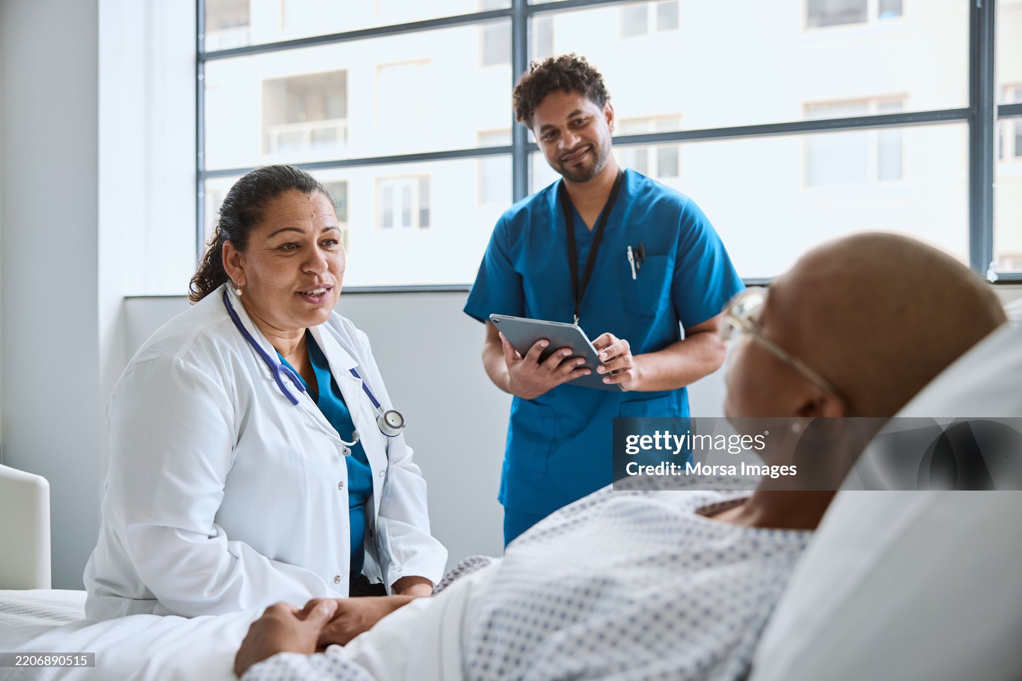 Doctor and medical staff member assisting a patient in a clinic setting, reflecting healthcare support and care.