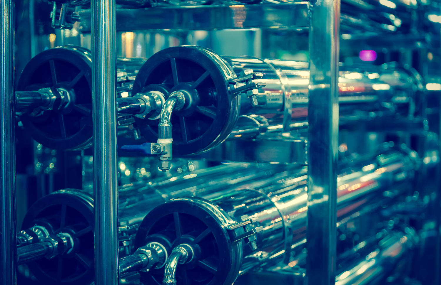 Industrial membrane cleaning equipment with multiple stainless steel pipes and valves.
